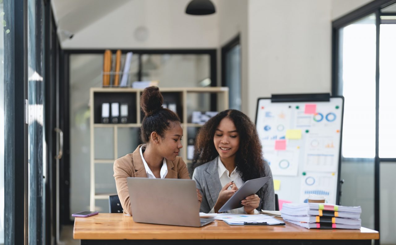 Two young business people working together in office. financial analysis accounting concept.